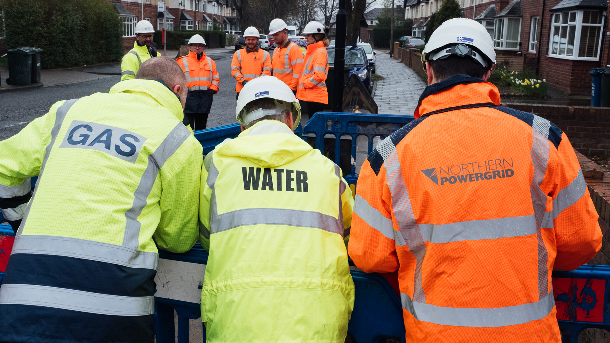Gas, water and power utilities looking at underground pipes and cables