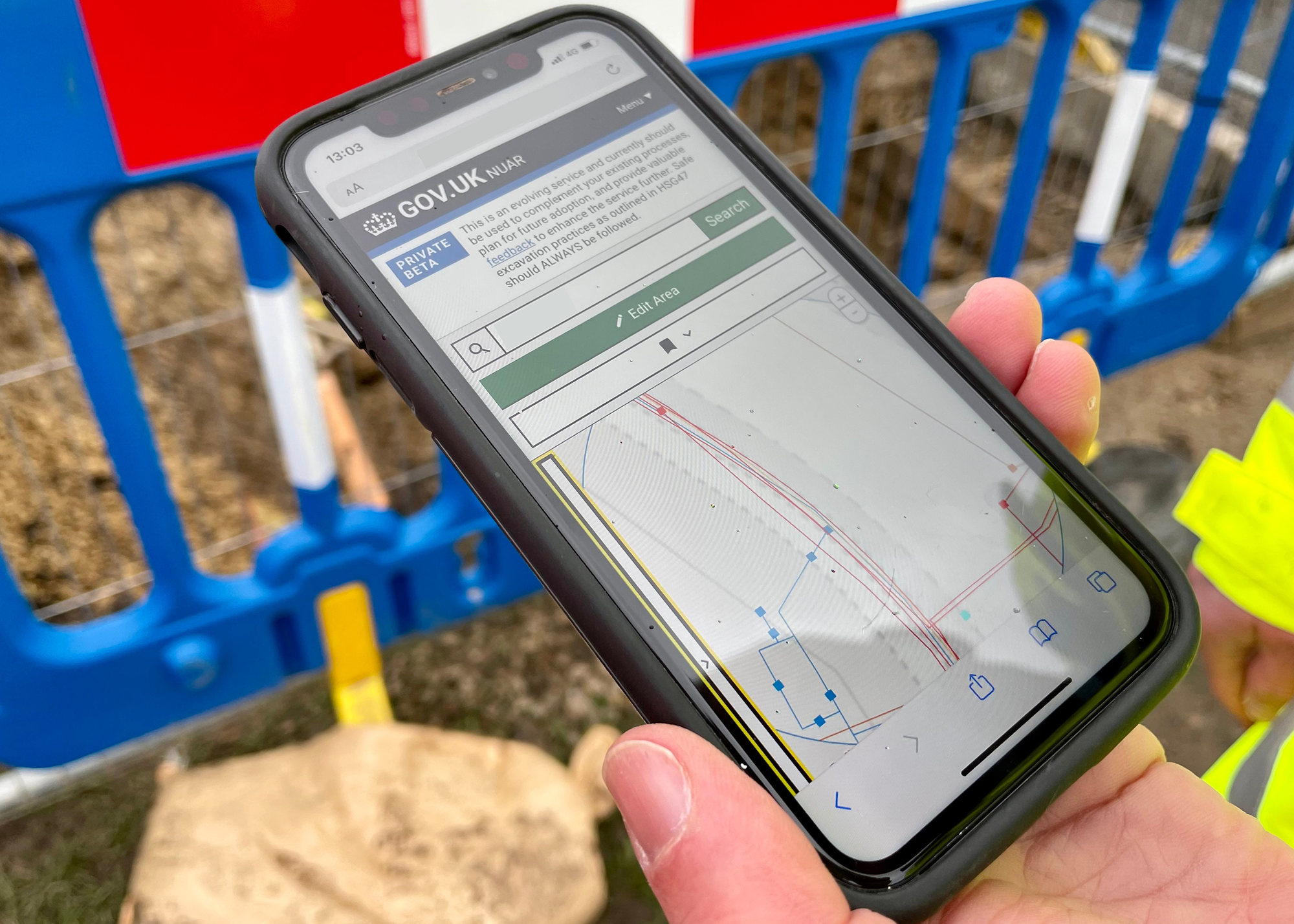 Close up of worker using National Underground Asset Register on mobile onsite