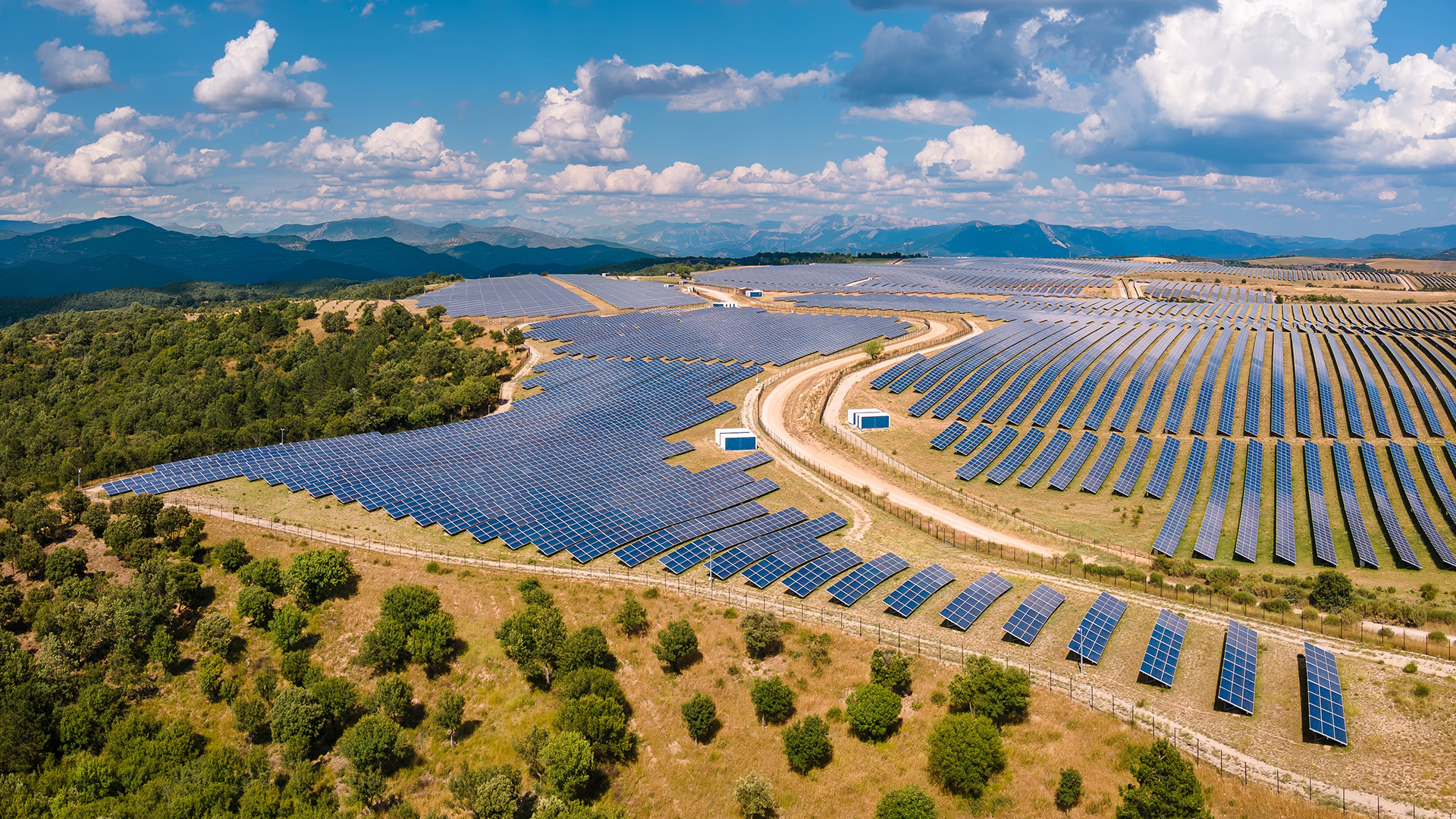 Vast landscape of solar panels, surrounded by mountains