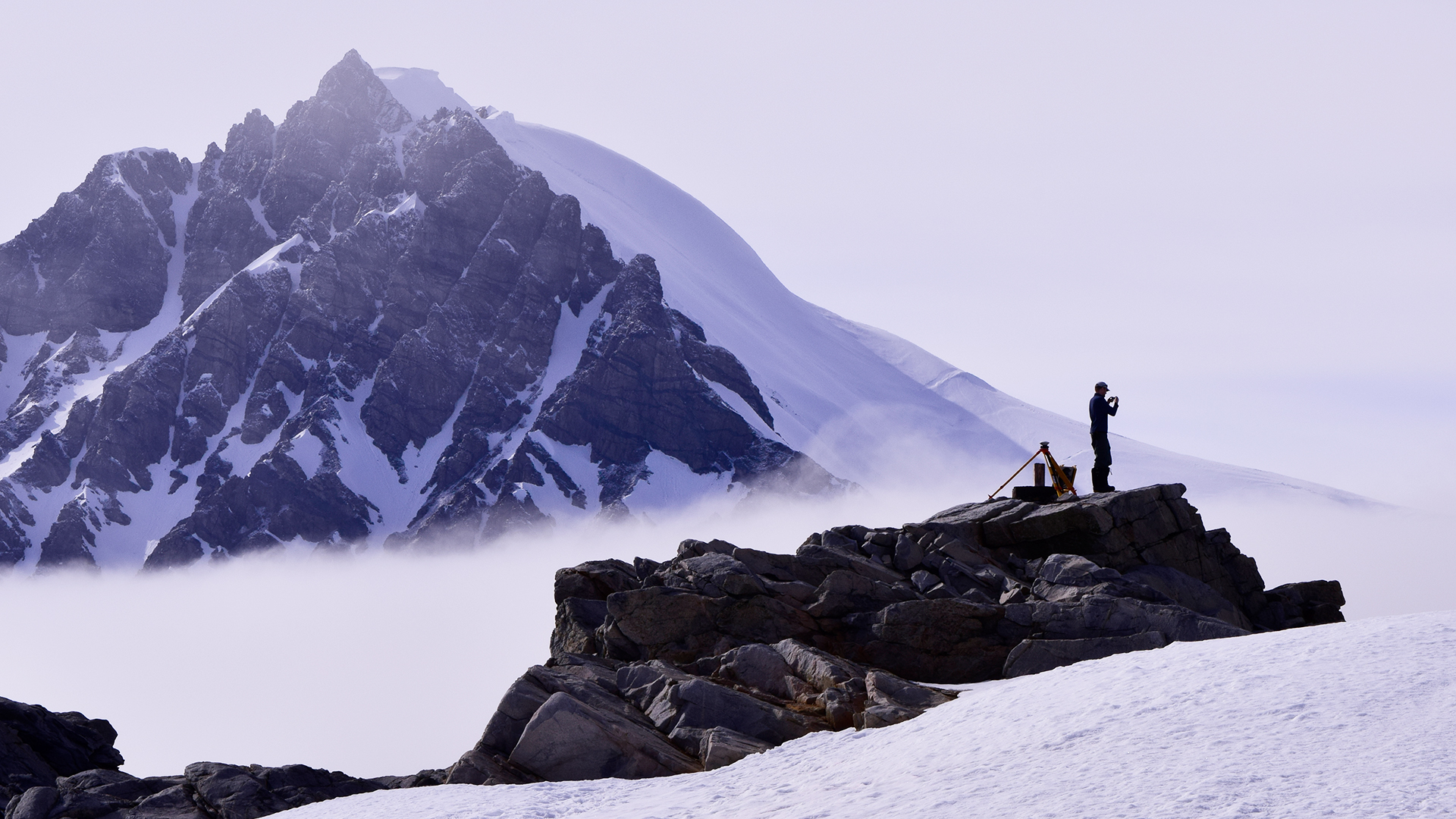 Nathan conducting a GNSS survey on Stonington Island, Antarctica, in support of a United Kingdom Antarctic Heritage (UKAHT) conservation project of Base E (Photo: Geoff Cooper)