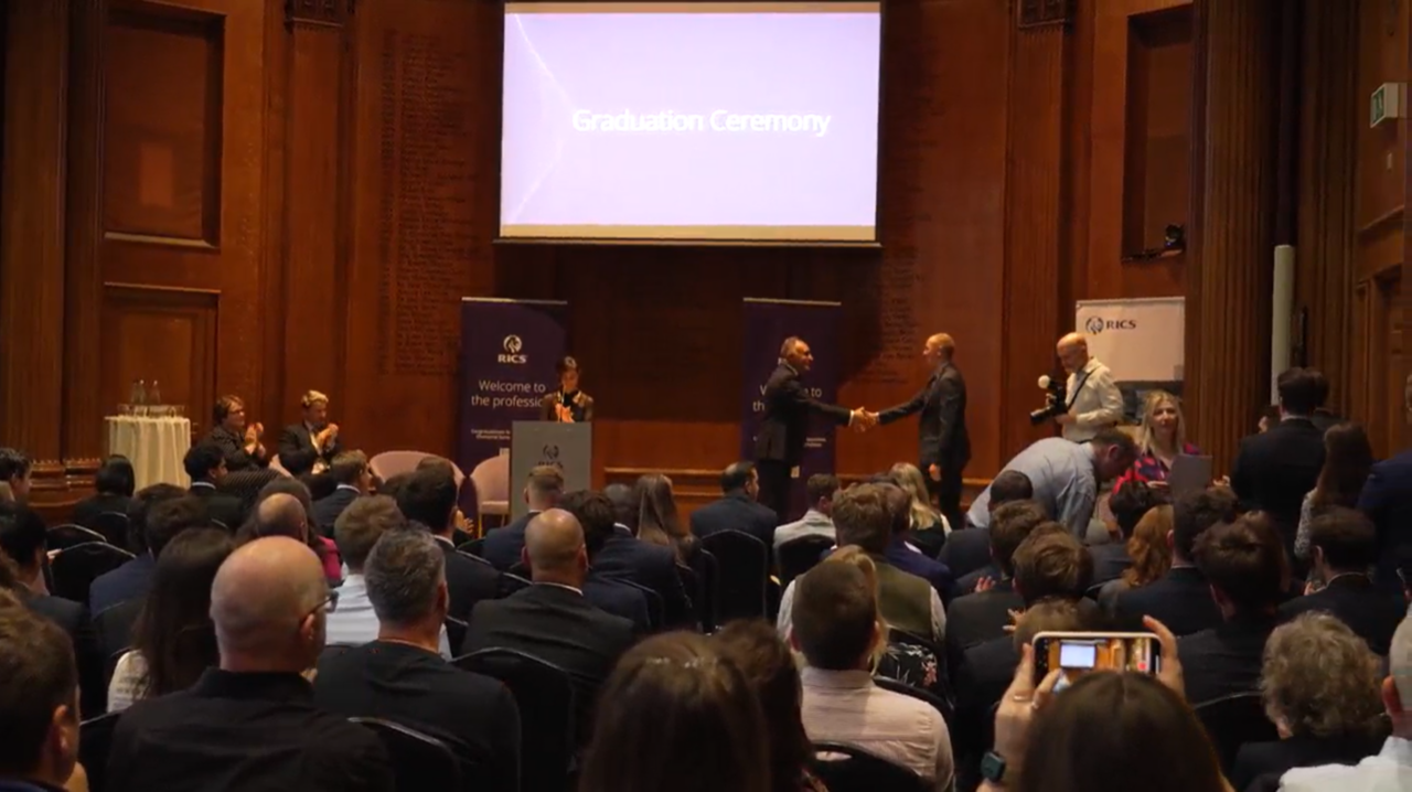 Welcome to the proession ceromony with people shaking hands on stage
