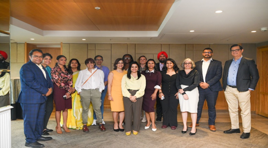 People standing and posing for a picture at the RICS in South Asia Cross-profession event