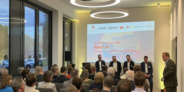 People sat and listening at RICS in Germany ResiTail - A New Love Between Residential and Retail event