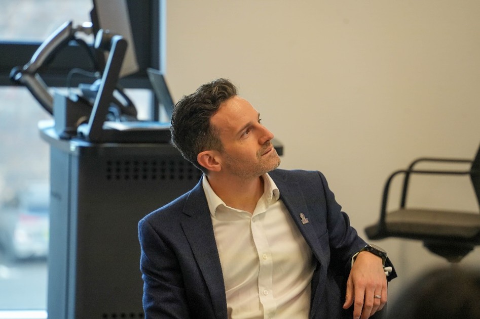 Ben Dean listening to one of the panelist talking whilst sat down