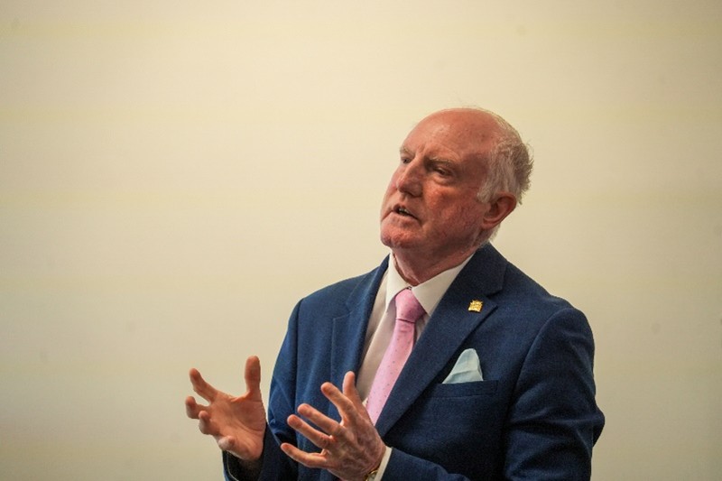 Dr Paul Hampton stood up talking to the attendees