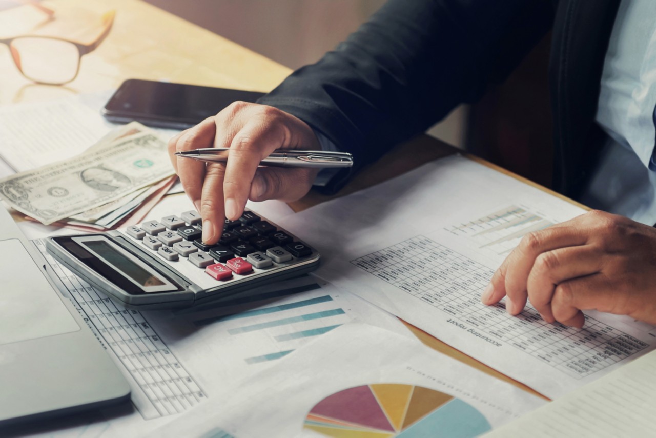 businessman using pen and calculator working in office. finance and accounting; Shutterstock ID 1166716996; Purchase Order: N/A